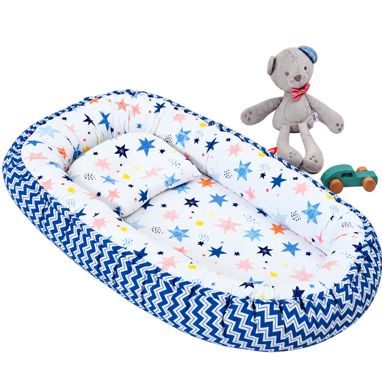 Baby Nest — Star-print baby nest with a blue patterned edge and matching pillow.